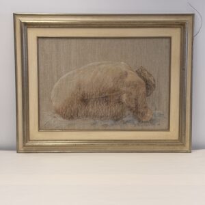Sheltered in its gold-coloured frame